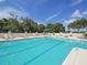 Resort-style pool with sun loungers, tables, and chairs offer a relaxing outdoor retreat at 5011 88Th E St, Bradenton, FL 34211