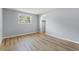 This bedroom has hardwood floors, fresh paint, modern lighting, and a closet at 530 Foxglove Rd, Venice, FL 34293