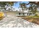 Charming single-story home with a large driveway, attached garage, and well-maintained lawn at 530 Foxglove Rd, Venice, FL 34293