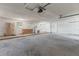 Spacious garage featuring a concrete floor, white walls, water heater and natural light at 530 Foxglove Rd, Venice, FL 34293