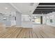 Open layout with hardwood floors, bar seating, and seamlessly transitioning to kitchen and dining at 530 Foxglove Rd, Venice, FL 34293