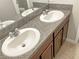 Bathroom features a double vanity sink and a large mirror at 14853 Crescent Rock Dr, Wimauma, FL 33598