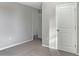 Another bedroom offers neutral walls, carpet, and two doorways at 14853 Crescent Rock Dr, Wimauma, FL 33598