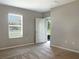 Bright bedroom with a large window, neutral walls, and plush carpeting at 14853 Crescent Rock Dr, Wimauma, FL 33598
