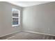 Bright bedroom with a window offers natural light and neutral walls at 14853 Crescent Rock Dr, Wimauma, FL 33598