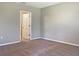 Spacious bedroom with plush carpeting, neutral walls, and a doorway that leads to another room at 14853 Crescent Rock Dr, Wimauma, FL 33598