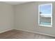 Cozy bedroom with neutral paint, carpet flooring, a window with blinds, and base molding at 14853 Crescent Rock Dr, Wimauma, FL 33598