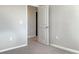 Neutral bedroom features plush carpet, baseboard trim, and a door at 14853 Crescent Rock Dr, Wimauma, FL 33598