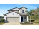 Charming two-story home with a well-manicured lawn and a beautiful, inviting entrance at 14853 Crescent Rock Dr, Wimauma, FL 33598