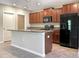 Kitchen features granite countertops, black appliances and ample cabinet space at 14853 Crescent Rock Dr, Wimauma, FL 33598