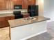 Kitchen featuring granite countertops, dark wood cabinets, and stainless steel appliances at 14853 Crescent Rock Dr, Wimauma, FL 33598