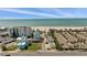 Stunning aerial view of beachside homes near the serene ocean waters and white sands at 318 182Nd E Ave, Redington Shores, FL 33708