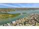 Expansive aerial shot showcasing waterfront homes with serene bay views and lush greenery at 318 182Nd E Ave, Redington Shores, FL 33708