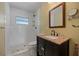 Bathroom has a stylish vanity with dark wood cabinets and a granite countertop, complemented by a tiled walk-in shower at 318 182Nd E Ave, Redington Shores, FL 33708