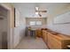 The bedroom is prepped for remodel, showing neutral walls, a ceiling fan, a closet and a window offering natural light at 318 182Nd E Ave, Redington Shores, FL 33708