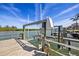 Exterior shot showcasing a weathered dock and boat lift, framed by clear waters and a serene waterfront at 318 182Nd E Ave, Redington Shores, FL 33708