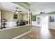 Open-concept living room featuring wood look tile floor, a piano and decorative accents at 4319 Gentrice Dr, Valrico, FL 33596