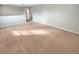 A large, open living room with neutral carpet and paint at 36880 Precita Ter, Zephyrhills, FL 33542