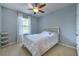 Cozy bedroom with a neutral color palette, a comfortable bed, and a serene atmosphere, ideal for restful nights at 3853 Silverlake Way, Wesley Chapel, FL 33544