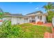 Backyard featuring brick flooring, a lawn area, a garage, and mature plants and trees at 546 15Th Ne Ave, St Petersburg, FL 33704