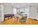 Cozy dining room featuring a round wooden table, four chairs, hardwood floors, and abundant natural light at 546 15Th Ne Ave, St Petersburg, FL 33704