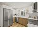 Well-lit kitchen features stainless steel appliances, floating wood shelves, and bright white countertops at 4501 4Th N Ave, St Petersburg, FL 33713