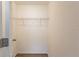 A standard reach-in closet with a wire shelf and wood-look flooring at 10221 N Oklawaha Ave, Tampa, FL 33617
