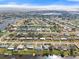 Expansive aerial view of waterfront neighborhood with canal access and single-Gathering homes under a sunny, blue sky at 511 Sharon Cir, Port Charlotte, FL 33952