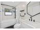 Renovated bathroom with modern fixtures, contemporary tiling, and combination tub and shower setup at 511 Sharon Cir, Port Charlotte, FL 33952