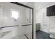 Elegant bathroom features glass-enclosed shower, new fixtures, and modern tiling with an adjoining vanity area at 511 Sharon Cir, Port Charlotte, FL 33952
