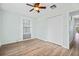 Bedroom with wood-look flooring, a closet, and a ceiling fan at 511 Sharon Cir, Port Charlotte, FL 33952
