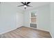 Bedroom featuring light walls, wood-look flooring, and a window with blinds at 511 Sharon Cir, Port Charlotte, FL 33952