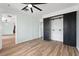 Well-lit bedroom has wood-look floors, barn door closet, ceiling fan, and easy access to additional rooms at 511 Sharon Cir, Port Charlotte, FL 33952