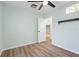 Cozy bedroom with wood-look flooring, ceiling fan, and updated trim at 511 Sharon Cir, Port Charlotte, FL 33952