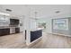 Bright and airy kitchen showcasing an island with dark cabinets and stylish hardware at 511 Sharon Cir, Port Charlotte, FL 33952