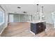Bright, open-concept living area with luxury vinyl plank flooring and a kitchen island with bar seating at 511 Sharon Cir, Port Charlotte, FL 33952