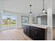 Spacious open-concept living area with light walls and a kitchen island with luxury vinyl plank flooring at 511 Sharon Cir, Port Charlotte, FL 33952