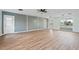 Open-concept living area showcases wood-look floors, neutral walls, and abundant natural light through large windows at 511 Sharon Cir, Port Charlotte, FL 33952