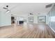Bright and airy living room features updated flooring, modern lighting, and views to the kitchen and outdoors at 511 Sharon Cir, Port Charlotte, FL 33952