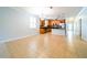 Bright kitchen and dining area with stainless appliances and black countertops, with view to entry door at 20227 Autumn Fern Ave, Tampa, FL 33647