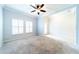 Bright living room featuring carpet flooring, ceiling fan, and an open layout at 20227 Autumn Fern Ave, Tampa, FL 33647