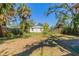 The back yard features some trees and vegetation and a partial view of the back of the house at 2634 E 38Th Ave, Tampa, FL 33610