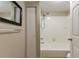 Bathroom featuring a tub and shower combo with white tile and a closet at 2634 E 38Th Ave, Tampa, FL 33610