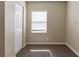 An empty bedroom with carpet, a window with blinds, and a closet at 2634 E 38Th Ave, Tampa, FL 33610