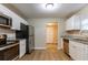 Modern kitchen with stainless steel appliances, white cabinets, and granite countertops at 2634 E 38Th Ave, Tampa, FL 33610