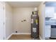 The laundry room features a hot water tank, connections for a washer and dryer, and is connected to the kitchen at 2634 E 38Th Ave, Tampa, FL 33610