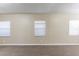 Living room featuring three windows, neutral colors, and neutral floors at 2634 E 38Th Ave, Tampa, FL 33610