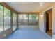 The sun room provides an indoor/outdoor living space overlooking the back yard, featuring a screen door to access the yard at 2634 E 38Th Ave, Tampa, FL 33610