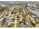 A high-angle view of a neighborhood showcasing many homes, lush landscaping, and a body of water nearby at 6731 Ranger Dr, Tampa, FL 33615