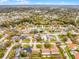 Aerial view shows neighborhood featuring mature trees, sidewalks, and community amenities at 6731 Ranger Dr, Tampa, FL 33615